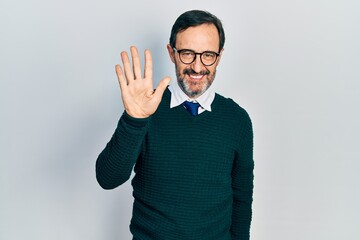 Middle age hispanic man wearing casual clothes and glasses showing and pointing up with fingers number five while smiling confident and happy.