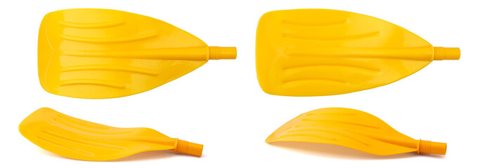 Plastic paddle of yellow color for an inflatable boat isolated from four angles on a clean white...