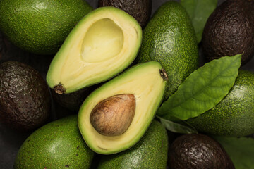 Ripe avocado close-up, whole and cut in half