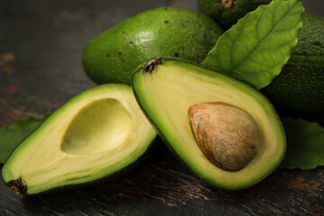 Ripe avocado close-up, whole and cut in half