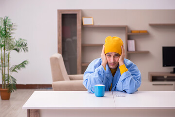 Young man suffering at home