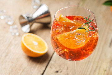 Classic Italian Aperol spritz cocktail in glass on wooden table