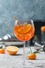 Classic Italian Aperol spritz cocktail in glass on gray background