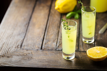 Traditional italian lemon liqueur limoncello and fresh citrus lemon. Alcoholic beverage.