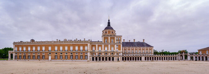 Great panoramic view of the lateral of the royal palace of Aranjuez on cloudy day at dawn. Madrid.
