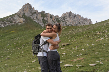 Young couple in love look at the wonderful panorama in the swiss alps