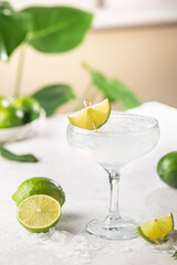 Refreshing Homemade Classic Alcoholic Margarita Cocktail with Lime and Salt on light background