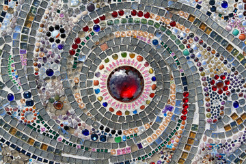 Many jewel or gem, colorful gravel and red diamond in middle or center decorated on wall for background. Pattern of stone or mosaic wallpaper at Thai temple. Art design