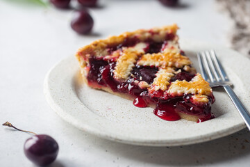 piece of Delicious homemade classic cherry pie with a flaky crust on white background