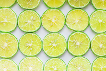 Food background. Sliced lemons neatly laid out on a white background. Suitable for use as a food background or artwork