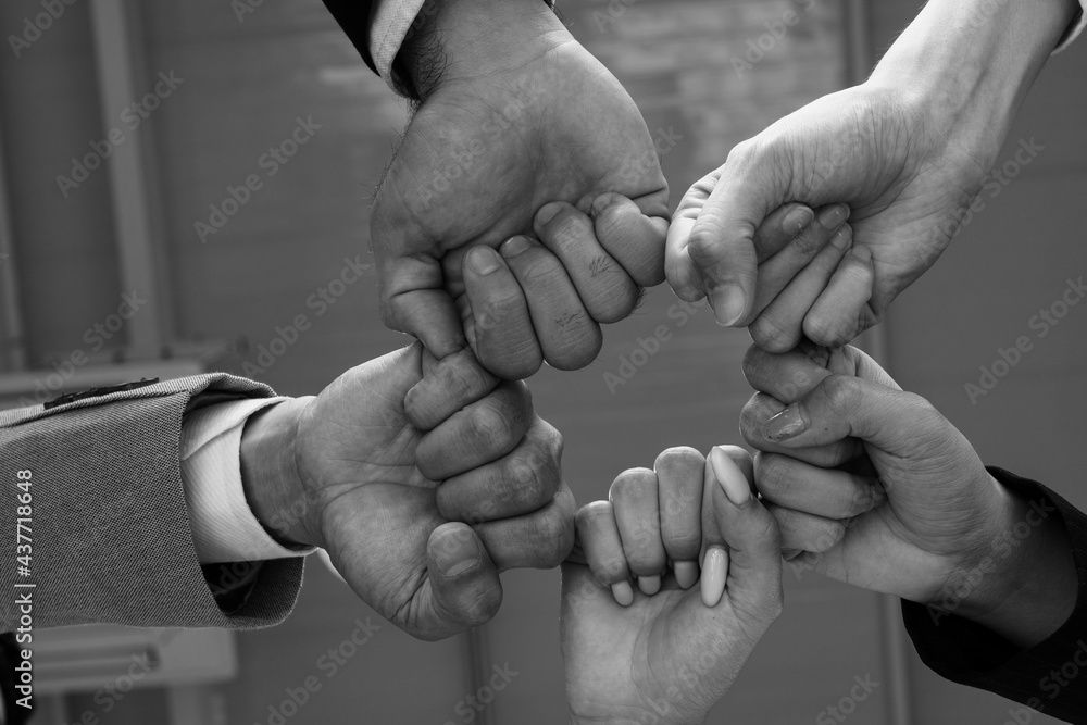 Wall mural close up picture of hands of multiethnic business team touching in circle for sign of unity and inte