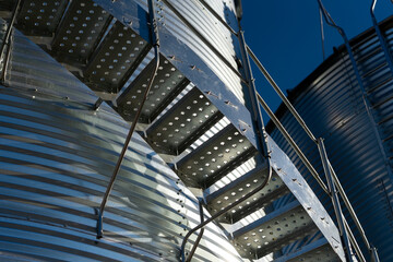 A close up detail photo of a shiny metal grain storage bin in western Canada