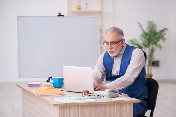 Old male designer working in the office