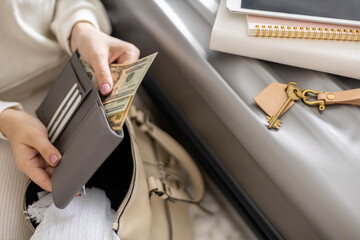 Female hands holding cash money dollars in wallet with cards ready travel vacation or business trip