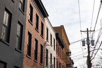 Row of Old Brick Residential Buildings next to Telephone Wires in Hoboken New Jersey