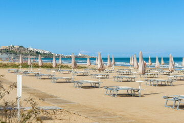 Obraz premium beach scene in Apulia Italy with umbrellas and sun loungers 