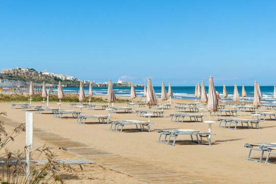 beach scene in Apulia Italy with umbrellas and sun loungers 