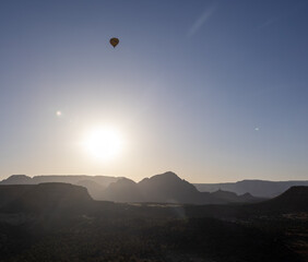 hot air balloon at sunrise over desert