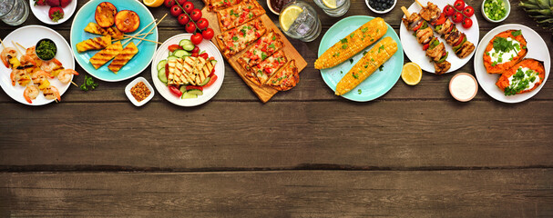 Summer BBQ grill top border over a dark wood banner background. Grilled flatbread, chicken and...