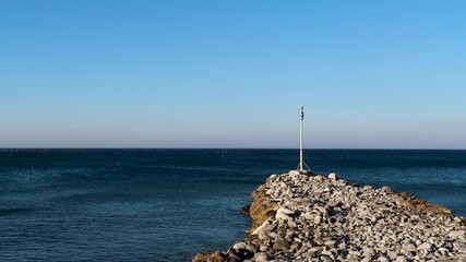 An HD footage of a dock in the Libyan Sea with the Greek flag