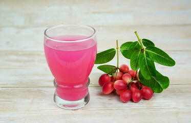 Iced Karanda fruit juice Put down a glass, Bengal-Currants, Carandas-plum, Karanda, Carissa carandas L, Is a fruit with high medicinal properties.	
