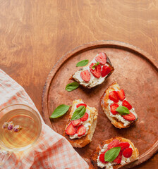 Strawberry toast brioche with cream cheese decorated with flowers and basil fflat lay close up