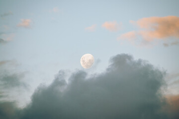 daytime moon with gray clouds