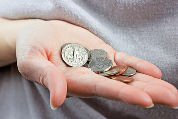 Caucasian woman hand holding and counting usa coin cents. Unemployment, poverty, savings and budget concept. - 437729232
