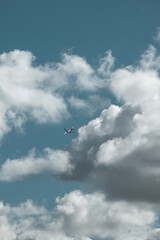 airplane flying in the sky on a cloudy day
