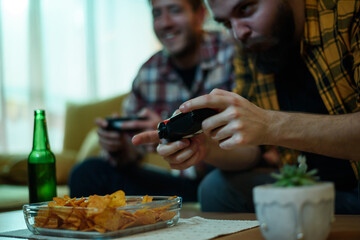 Two best friends playing video games while relaxing at home