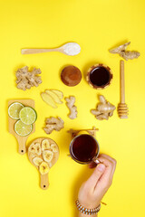 Various dried fruits lime ginger honey tea, on a yellow background. Top view. Flat lay