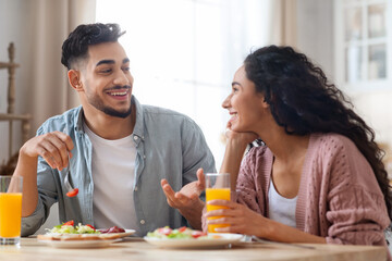 Fototapeta na wymiar Domestic Morning. Closeup Portrait Of Happy Middle Eastern Couple Eating Breakfast Together