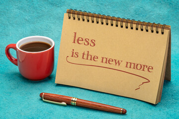 less is the new more - minimalism concept, handwriting in a spiral notebook with a cup of coffee
