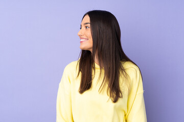 Young caucasian woman over isolated background looking side