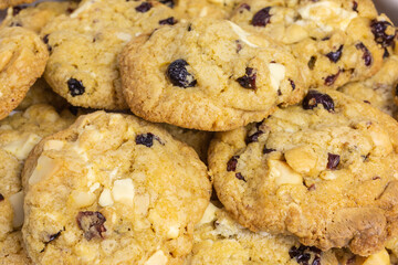 background of homemade cookies with cranberry, white chocolate and macadamia nuts