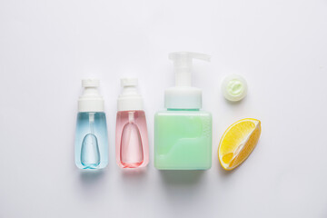 Natural cosmetic products with citrus fruit on white background