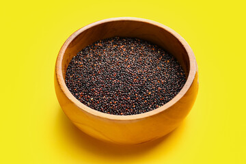 Bowl with healthy quinoa on color background