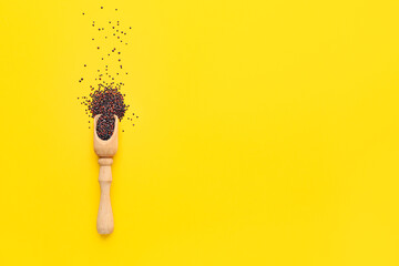 Scoop with healthy quinoa on color background