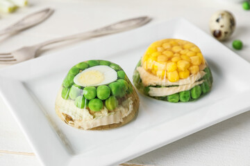 Plate with tasty aspic on table