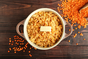 Pot of tasty cooked lentils on table