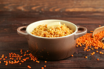 Pot of tasty cooked lentils on table