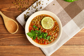 Bowl of tasty lentil soup on table