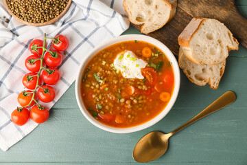 Bowl of tasty lentil soup on table