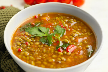 Bowl of tasty lentil soup on table, closeup
