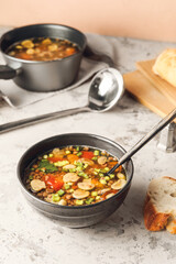 Bowl of tasty lentil soup on table