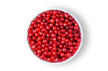 Lingonberry or cowberry or partridgeberry or foxberry. Ripe berries in a white plate. Isolated on...