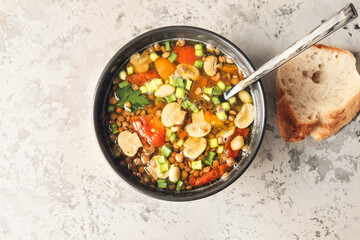 Bowl of tasty lentil soup on grunge background
