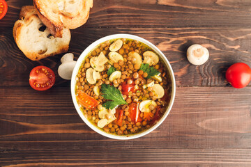 Bowl of tasty lentil soup on table