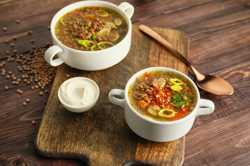 Pots of tasty lentil soup on table