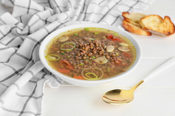 Bowl of tasty lentil soup on table